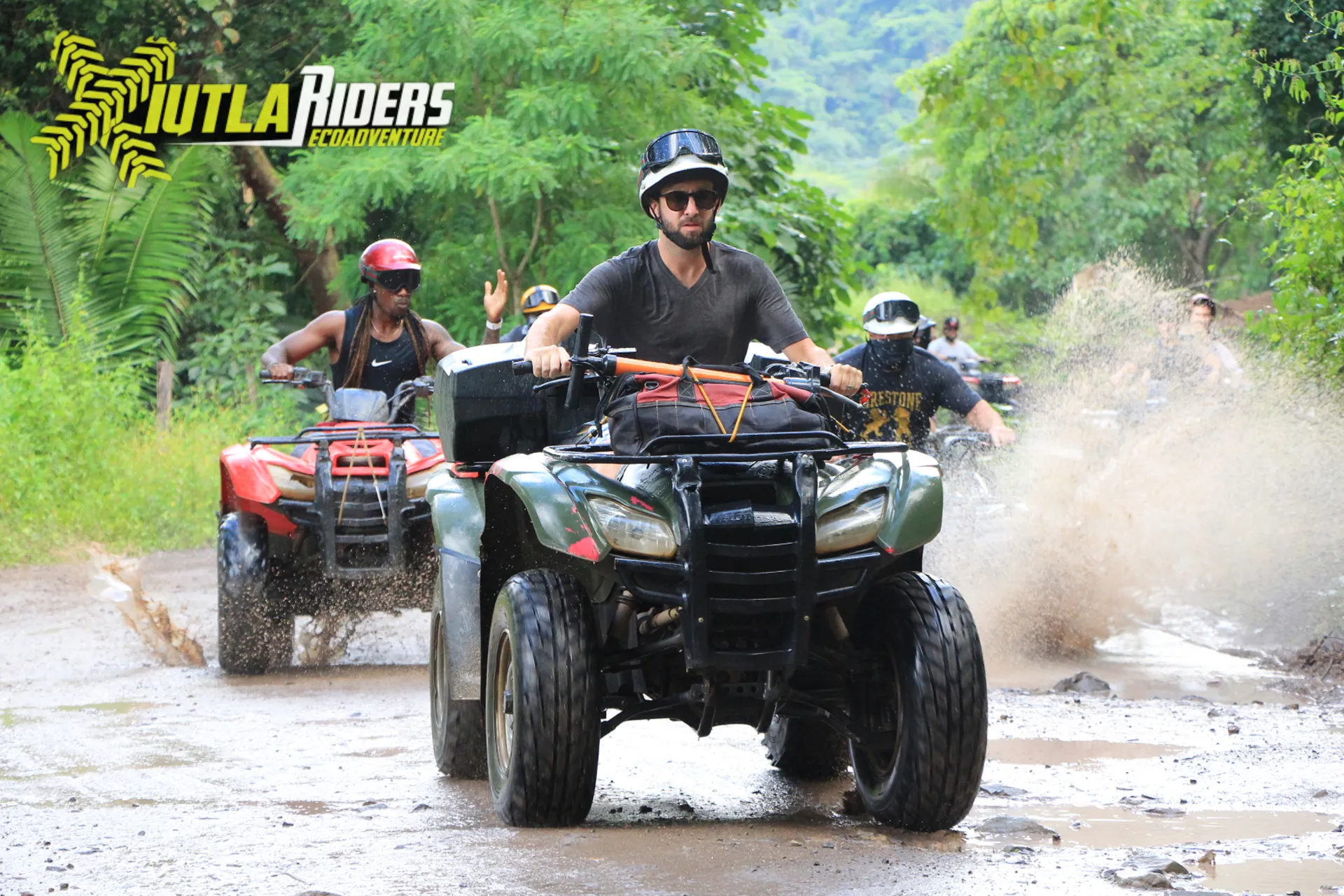 A group of people renting ATVs for a muddy trail adventure.